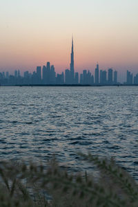 View of buildings in city during sunset