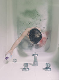 Girl taking bath in tub at home