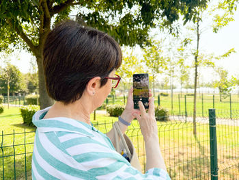Young woman photographing with camera