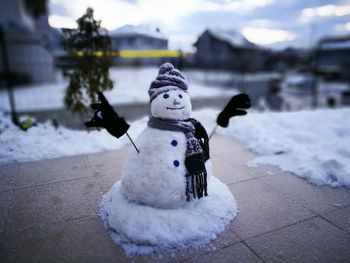Snowman on footpath during winter