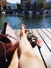 Low section of woman relaxing on lake