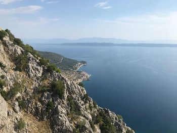 High angle view of sea and mountains against sky