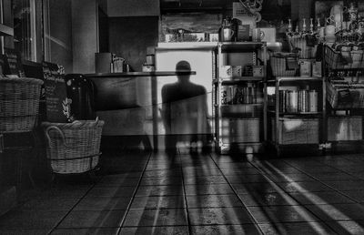 Rear view of a woman walking on tiled floor