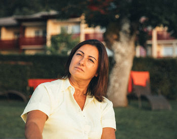 Portrait of young woman standing outdoors
