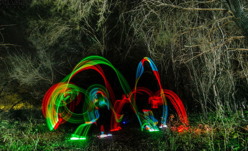 Panoramic view of people at illuminated field