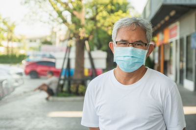 Portrait of man standing on street