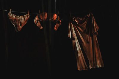 Clothes drying on black background