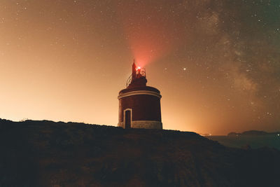 Lighthouse against sky at night