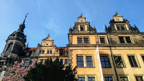 Low angle view of buildings against blue sky