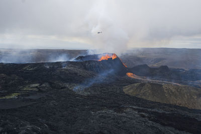 Smoke and lava emitting from volcanic mountain