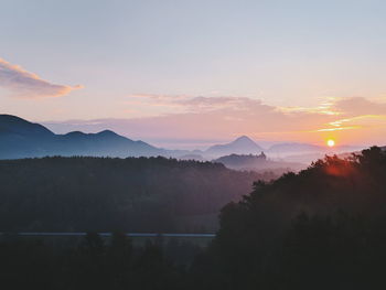 Silhouette of mountain against cloudy sky