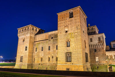 Low angle view of historic building against blue sky