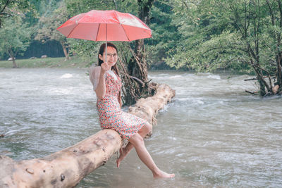 Full length of man on wet umbrella at rainy season