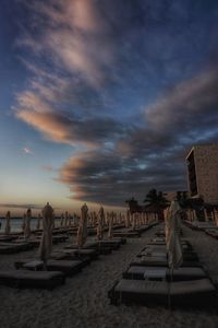 Scenic view of beach against sky at sunset