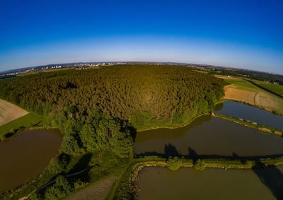 Scenic view of landscape against blue sky