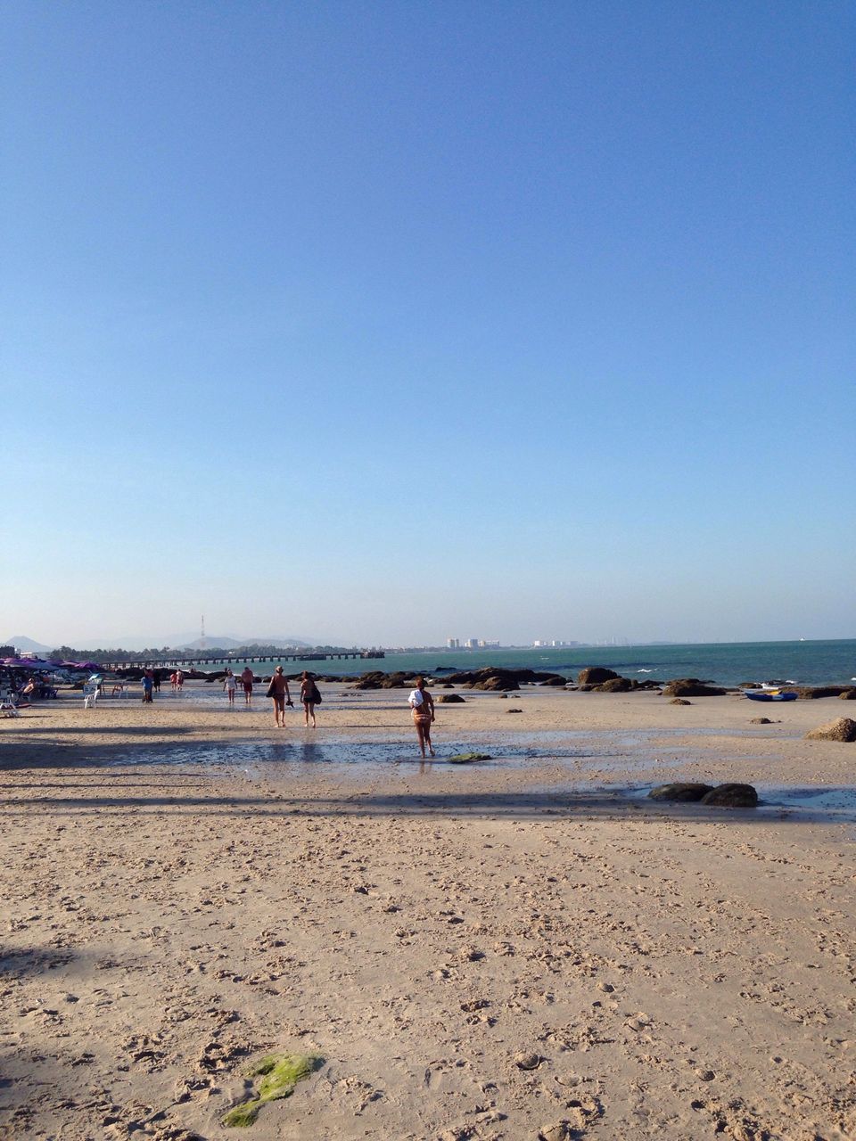 beach, clear sky, sea, copy space, sand, water, shore, leisure activity, lifestyles, vacations, large group of people, horizon over water, blue, men, tranquility, scenics, tranquil scene, enjoyment, nature