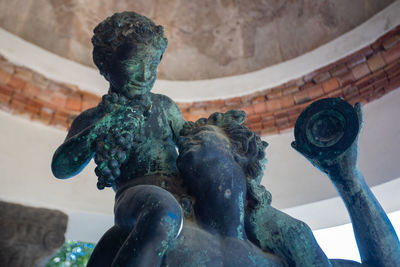 Low angle view of statue against building