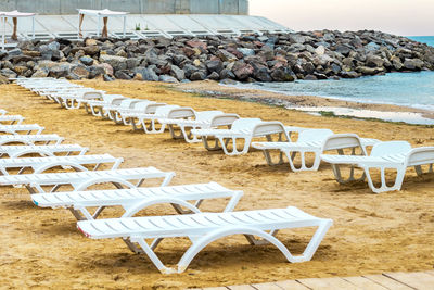 White sunbed on the sand beach at the sea, summer sea rest concept.