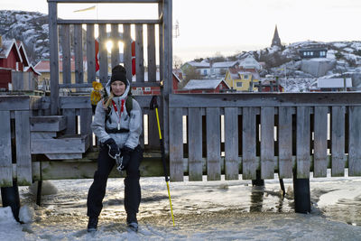 Ice-skater sitting on bench and looking at camera