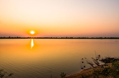 Scenic view of lake against sky during sunset