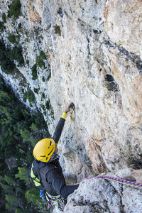 High angle view of man climbing on wall