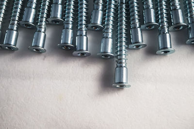 Close-up of metallic screws on table