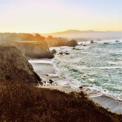 Scenic view of beach against sky during sunset