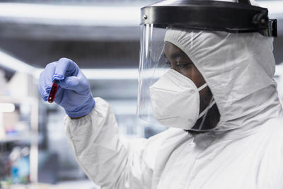 Midsection of doctor holding dentures