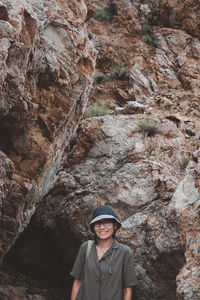 Portrait of woman standing on rock