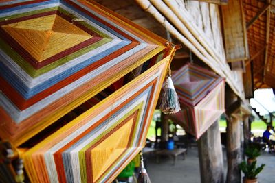 Low angle view of multi colored umbrellas hanging outside temple