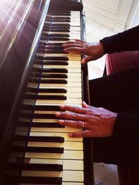 Cropped image of woman playing piano
