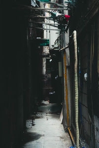 Narrow alley amidst buildings in city at night