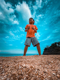 Full length of man standing on beach