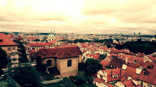 Cityscape against cloudy sky