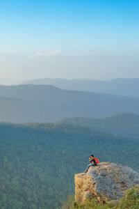 Man on mountain against sky