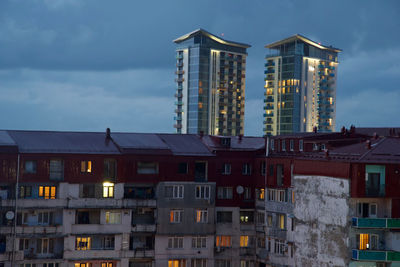 Low angle view of illuminated buildings against sky