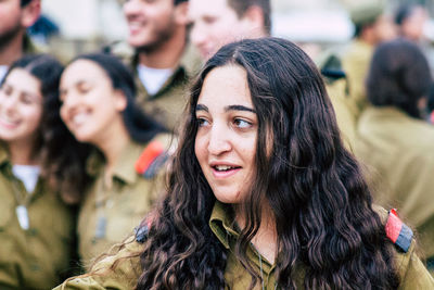 Portrait of smiling young woman looking away outdoors