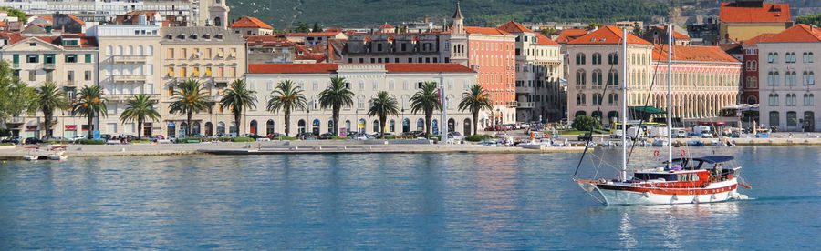 The sailboat leaves split port. the sailboat leaves split port. in the background is riva promenade.