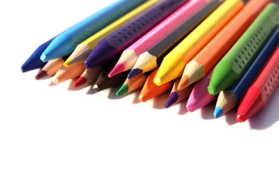 Close-up of colored pencils against white background