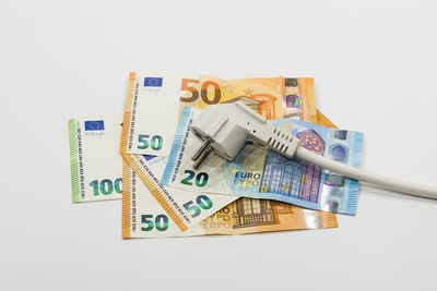 The electric power plug on euro banknotes. concept of expensive electricity costs