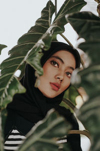 Portrait of woman against plants