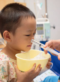 Close-up portrait of boy drinking coffee