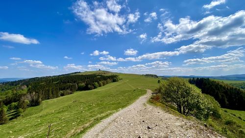 Scenic view of landscape against blue sky