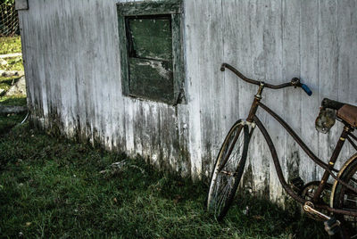 Old bicycle leaning on grass