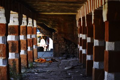 Rear view of people walking in corridor of building