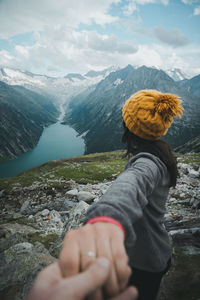 Young woman walking on the mountain top over blue lake view. travelling together