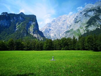 Scenic view of field and mountains against sky