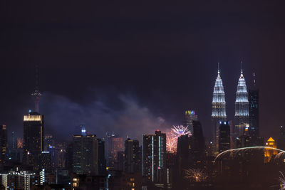 View of skyscrapers lit up at night