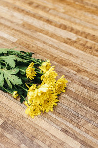 Close-up of yellow flowers on wood