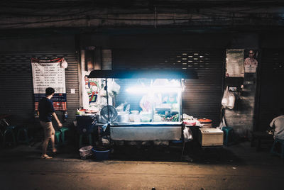 Illuminated food stall on street at night